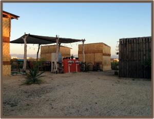 a building with awning and a red gas station at Camp - Santos Camp With All The Comforts in Todos Santos