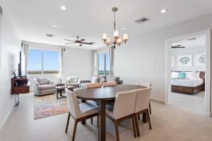 a dining room and living room with a table and chairs at Sunset Caribe Belize in San Pedro +54 photos