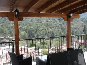 a balcony with chairs and a view of a mountain at Love Holiday Suite 2 in Tris Elies