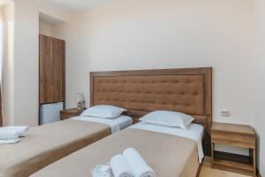 two beds sitting next to each other in a room at Gala Boutique Hotel in Kutaisi