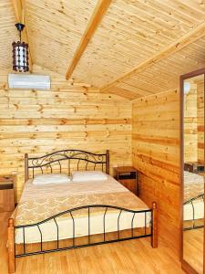 a bedroom with a bed in a log cabin at U Valentiny in Novy Afon