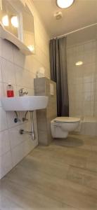a bathroom with a sink and a toilet at Steakhaus Galgenbach in Werne an der Lippe +43 photos