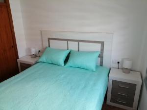 a bedroom with a blue bed with two blue pillows at Apartamento Paraíso en Santa Pola in Santa Pola +53 photos