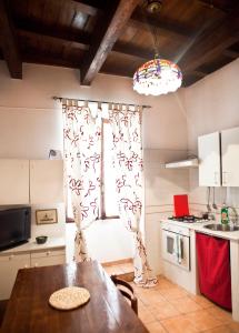 a kitchen with a wooden table and a window at Casa Vacanze Scolanova in Trani