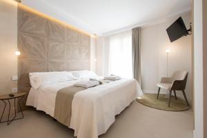 Postel nebo postele na pokoji v ubytování Hotel 1877 Sensaciones & SPA ADULTS ONLY