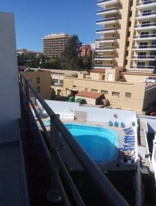 a swimming pool on the side of a building at Charming Holidays in Martiánez Beach in Puerto de la Cruz