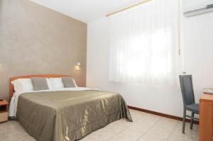 Postel nebo postele na pokoji v ubytování Hotel La Perla