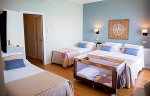 Postel nebo postele na pokoji v ubytování Hotel Punta Nord Est