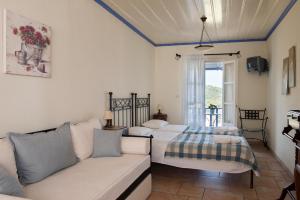 a living room with two beds and a couch at Chiliadromia Studios in Alonnisos