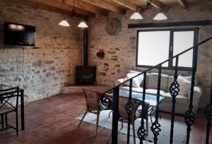 a living room with a couch and a table and a television at FUENTETRIGO II in Brizuela