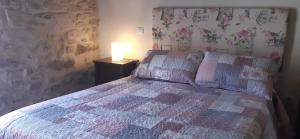 a bedroom with a bed and a lamp on a table at FUENTETRIGO II in Brizuela