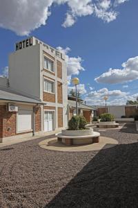 a hotel with a building with a clock on it at Río Hotel in Río Colorado