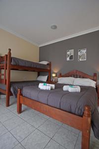 a bedroom with two beds with towels on them at Río Hotel in Río Colorado +95 photos