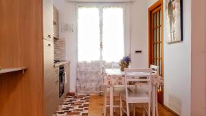 a kitchen with a table and chairs and a window at Guest Holiday Piave 1 in Reggio Emilia