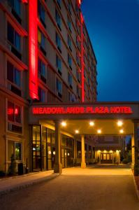 un hotel con un letrero de neón rojo delante de él en Meadowlands Plaza Hotel, en Secaucus
