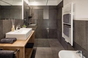 a bathroom with a sink and a mirror at Sweet Dolomiti Sonneck in Maranza +23 photos