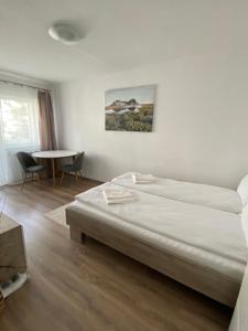 a bedroom with a bed and a table in it at Focus Home Next in Miercurea-Ciuc