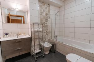 a bathroom with a sink and a toilet and a tub at Authentic Porto Apartments in Porto +72 photos