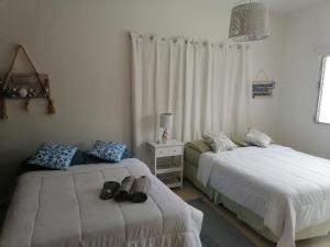 Een bed of bedden in een kamer bij La Perla de Farallon