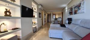 a living room with a couch and a tv at El Ancla in Tazacorte