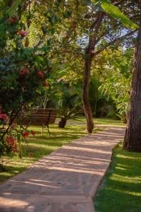 a path in a park with a bench and trees at Adega Cipó Pousada Serra do Cipó in Serra do Cipo +109 photos