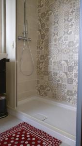 a shower in a bathroom with a red rug at Caicai Bed And Breakfast in Saluzzo +93 photos