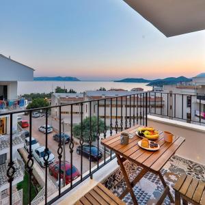 a balcony with a table with fruit on it at Sanisu pansiyon in Kas