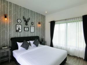 a bedroom with a large white bed and a window at Lux9 Private Pool Villa HuaHin in Hua Hin +29 photos
