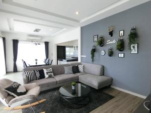 a living room with a couch and a table at Lux9 Private Pool Villa HuaHin in Hua Hin