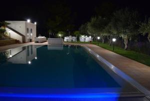 a swimming pool in a yard at night at Casevacanze Le Muse in Menfi