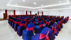 a room filled with blue chairs with red bows at Sobralia Casino Resort & Spa in Namchi