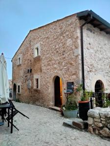 a large brick building with a door in it at IL BORGO DI ROCCA CALASCIO in Calascio