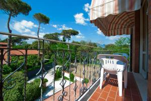 a balcony with a view of a garden at Hotel Versilia in Lido di Camaiore