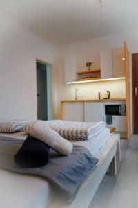 a room with two beds with towels on them at IWONA Pokoje Apartamenty in Karwia