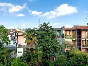 a palm tree in a city with buildings at Hotel Astrid in Milan