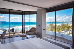 a bedroom with a view of the ocean at Yacht Hotel in Vlorë
