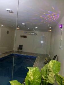 a swimming pool in a room with a ceiling at شاليهات السعد بالطايف in Taif
