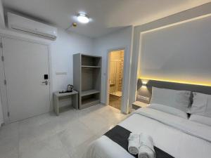 a bedroom with a large white bed and a closet at La Veranda Hotel in Larnaca