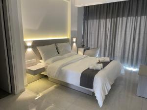 a bedroom with a large bed and a window at La Veranda Hotel in Larnaca