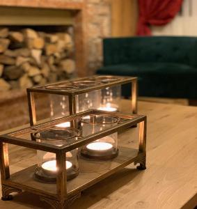 a glass table with candles on top of a table at Xenonas Iresioni in Arachova