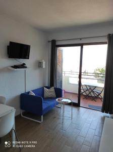 a living room with a couch and a table and a window at Fabulous Sea view Studio near old town Albufeira in Albufeira