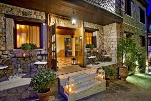a house with a staircase leading to the front door at Xenonas Iresioni in Arachova