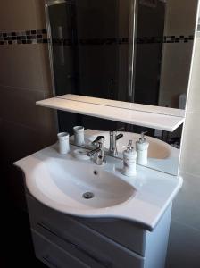 a bathroom with a white sink and a mirror at Rab Apartments Žic in Kampor +15 photos