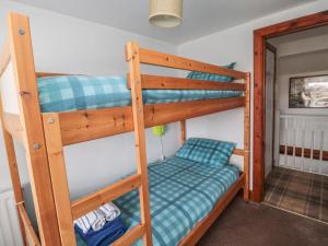 um quarto com 2 beliches num quarto em Chillingham Cottage em Belford