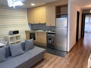 a living room with a couch and a kitchen at Apartamento Casa Latre in Barbastro