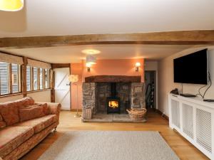 a living room with a couch and a fireplace at The Granary in Hereford