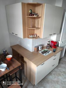 a kitchen with white cabinets and a wooden counter top at Pretty and quiet top floor 2 bedroom flat in the port area of Nice in Nice