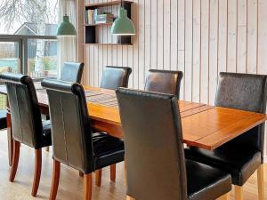 a dining room table with black chairs around it at Two-Bedroom Holiday home in Stubbekøbing 2 in Stubbekøbing