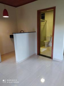 an empty room with a toilet and a counter at Suites Cantinho de Minas in Lavras Novas +17 photos