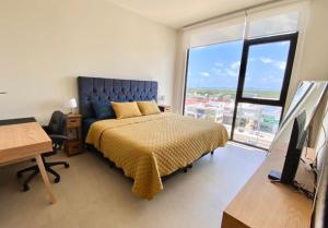 a bedroom with a bed and a desk and a television at San Francisco by Andiani Travel in Cancún